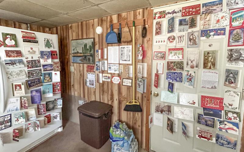 Larry Pratt is pictured with newly arrived Christmas cards. Inset photo, cards displayed at Pratt’s residence.