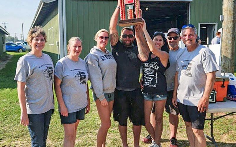 Jason Biskner raising the trophy after winning the 10th annual ORV Fun Fest. Inset photo, The ORV Fun Fest Parade kicked off with a 10 a.m. parade through Gladwin. PHOTOS PROVIDED BY CARRIE WILL