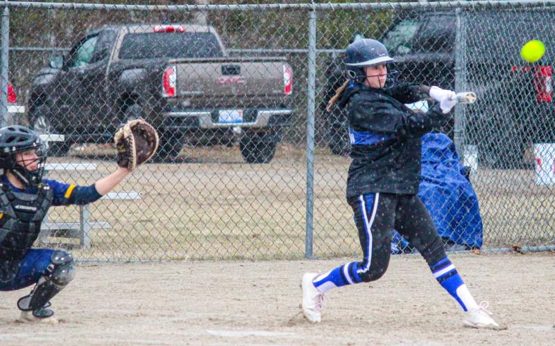 Gladwin batters continue knocking the ball during Tuesday’s rainy hail.