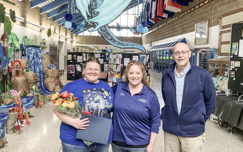 Gladwin Visual Arts Teacher Amber Billman received a Mayoral Proclamation from Sarah Kile with Superintendent Chuck Frisbie on hand for the ceremony Wednesday in a school bedecked with art.