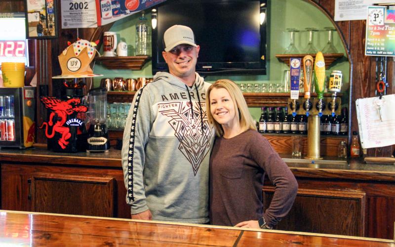 Randy (left) and Laura McDonald stand behind the bar of Piper’s Pub in Gladwin as new business owners.