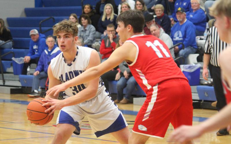 Gladwin’s Connor Dee, guarded by Beaverton’s Landon Love, looks for an open teammate to pass to.