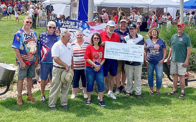 County Commissioner Mike Visnaw and County Veterans Affairs Director Ken Roberts team up to hold a big check that was donated to the Veterans Relief Fund Saturday. Also pictured: Mike Fitch, first tee shooter and George Alward, Chairman of the Gladwin County Veterans Council. Also, Sugar Springs Board of Directors Jeff Weeman, Craig Taunt, June Jucewicz, Sherri Visnaw, Tom Hug, and Eve Kaltz.