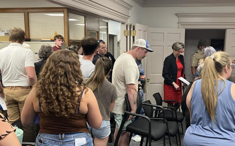 Residents attending Monday’s Regular Meeting of the Gladwin City Council grab a chair and head outside after the maximum capacity for City Hall was exceeded.