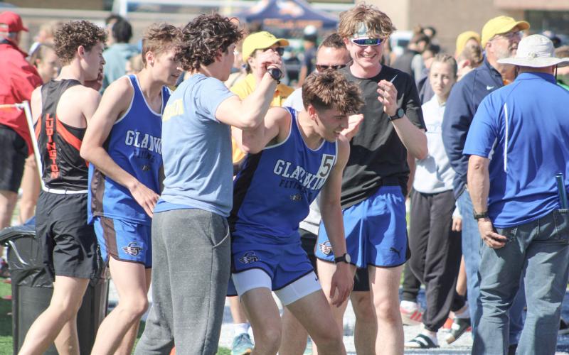Ben Verellen is congratulated by his teammates after confirming that his time in the 1600 was good enough to earn him a trip to the state meet.