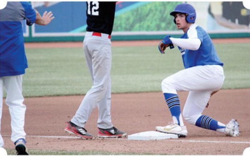 Gladwin’s Connor Dee slides, safely, into third base.