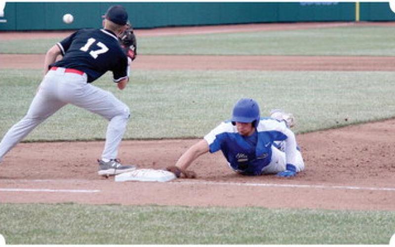 Gladwin slides back to first base, beating Layk Woodruff to the punch.