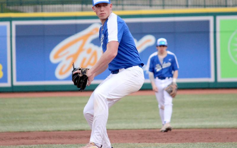 Pictured at left, Lucas Mead opens the game as Gladwin’s starting pitcher. At right, second baseman, Hunter Mitchell, locates the ball, ready to make the play for the Beavers.