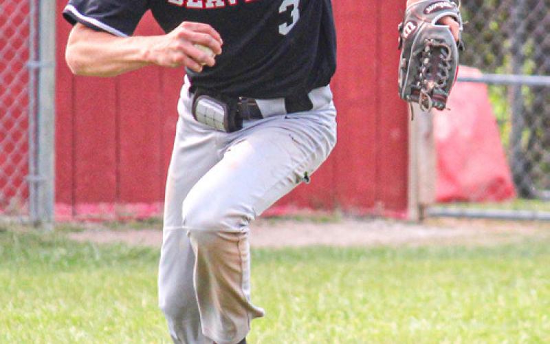 Pitcher Al Pahl makes his way to first base after scooping a ground ball hit near the mound.