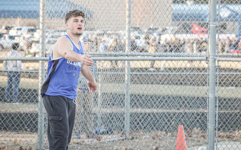 Gladwin’s Harvey Grove watches the flight of the discus during a meet earlier this season. Grove was fourth in the disc and won the championship in the shot at the JPC Meet.