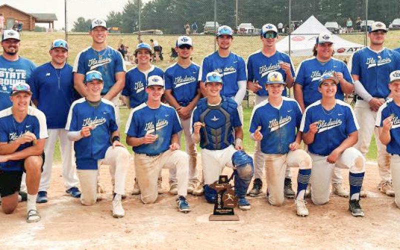 The Gladwin Flying G’s with their 2023 District winning trophy after Saturday’s victory over the Cadillac Vikings.