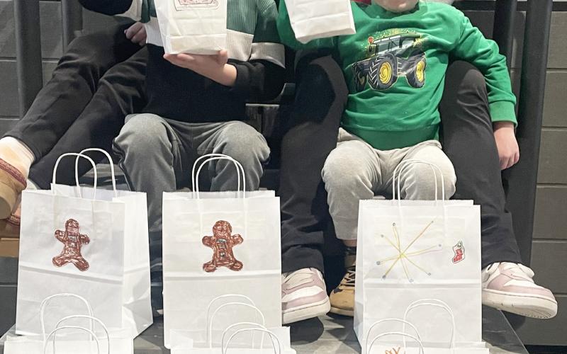 Pictured are Caroline, Lily, Logan and Connor, the spirited children of Tyler and Angela McLaren, display their handiwork after decorating gift bags for homebound Gladwin County residents. They are the grandchildren of Tina and Mike Haines, Kim and Pat Savage, and Mark and Amy Baker, all proud Beaverton residents.