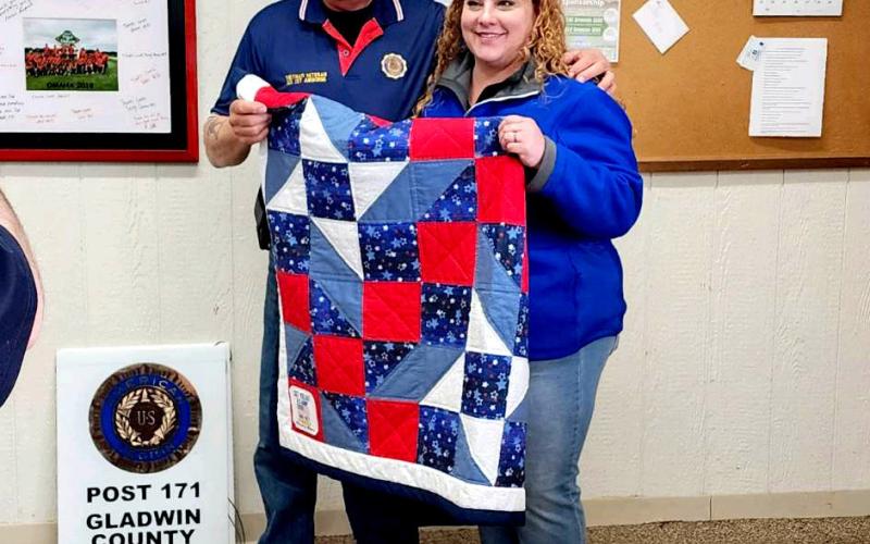 Pictured is Jim Volant (left) who was presented with a Threads of Tribute Quilt at the regular meeting of the Gladwin County American Legion Post 171 on April 20, 2023, by Gladwin Mayor Sarah Kile (right) who nominated him for his service during the Vietnam Era.
