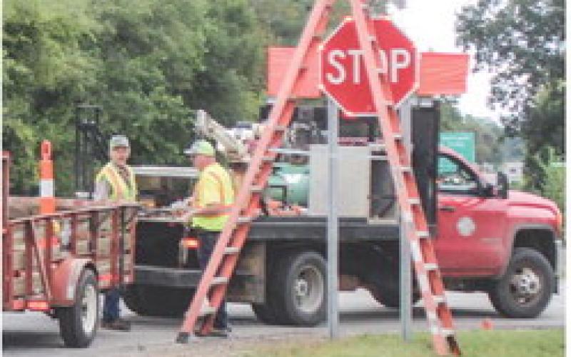 The Gladwin County Road Commission putting up the new stop signs at the Pratt Lake and Chappel Dam intersection.