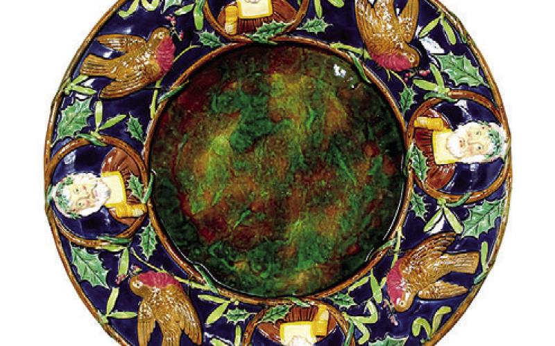Victorian English majolica maker George Jones decorated this platter with English Christmas symbols that may be unfamiliar to Americans, but still have the spirit of the holiday. STRAWSER AUCTION GROUP