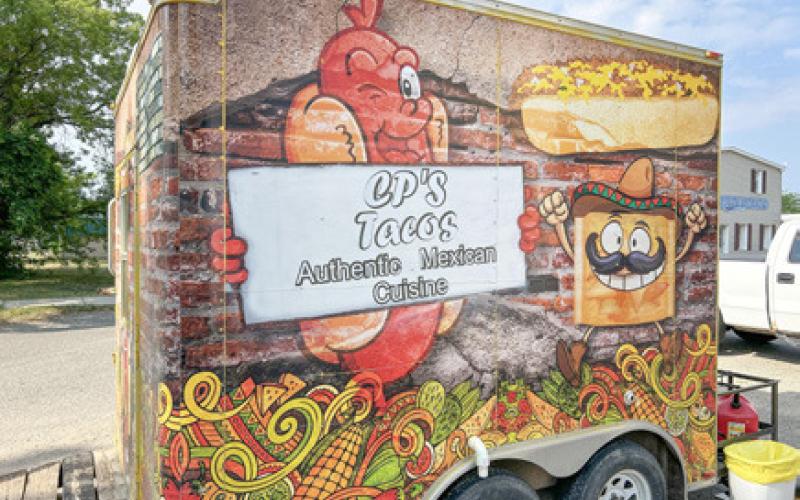Venders lined up on the side of the Rugged Den Outfitters and Spotted Cheetah Boutique building. Inset photo, CP’s Authentic Mexican Cuisine food truck in the Rugged Den Outfitters and Spotted Cheetah Boutique parking lot during the Maker’s Event.