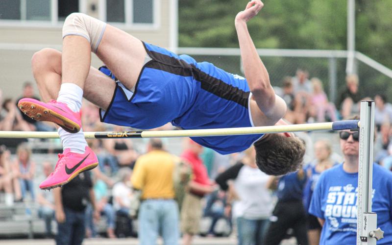 Clearing the pole in the high jump event.