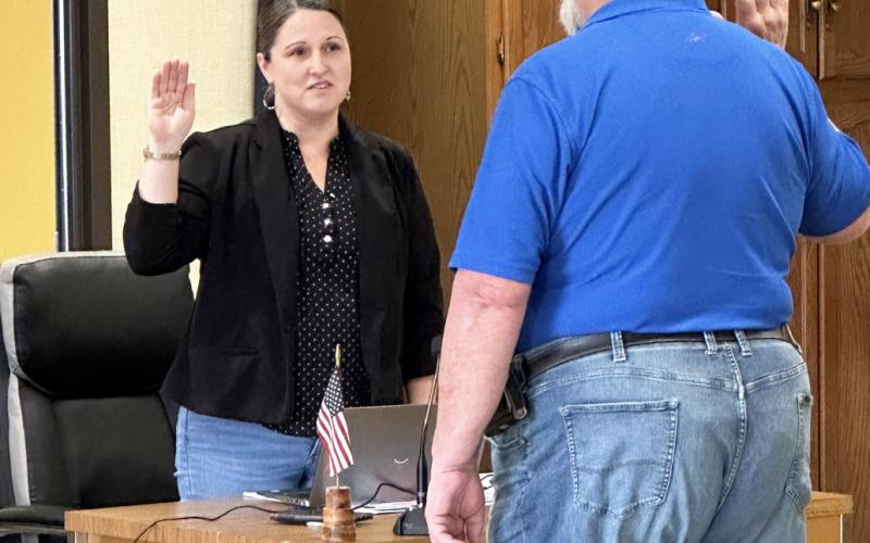 Gladwin County Clerk, Karrie Hulme, swears in Michael Visnaw. Inset photo, Michael Visnaw.