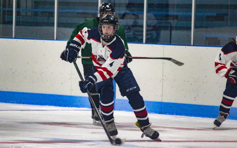 Looking to score, the Gladiators push the puck down the ice.