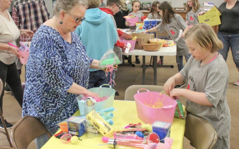 Adults helped Kid’s Club kids build the Easter baskets.