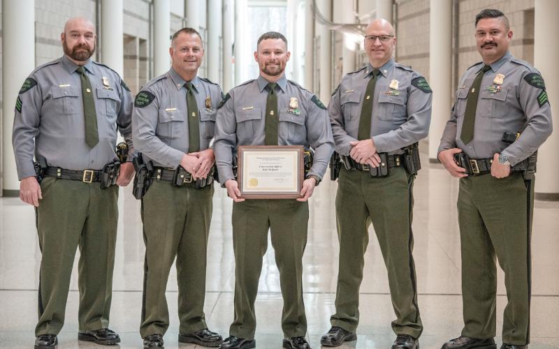 Michigan DNR Conservation Officer Kyle McQueer is pictured with leadership from the DNR Law Enforcement Division, including (left to right) Acting 1st Lt. Stephen Mooney, Chief Brandon Kieft, McQueer, Acting Asst. Chief Gerald Thayer and Sgt. Chris Holmes.