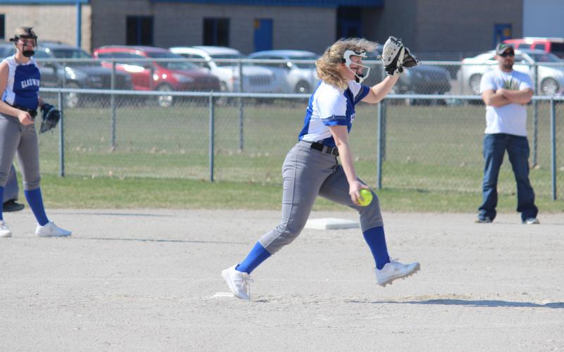 Gladwin pitches the ball to open up the first inning. Inset photo, Gladwin’s shortstop lining up to make the catch.