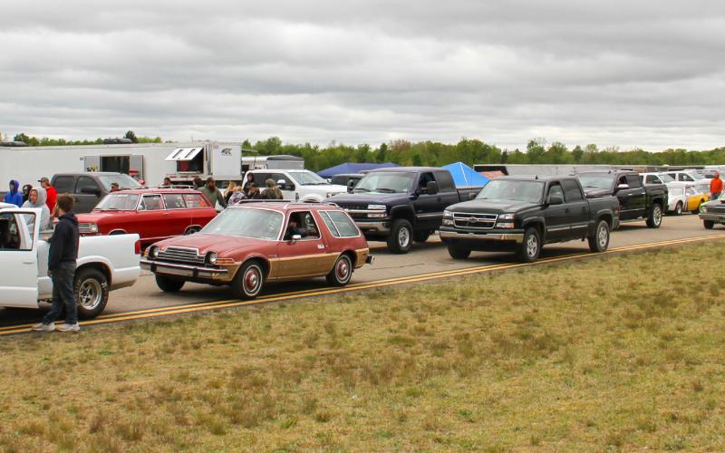Above: Racers line up along the Gladwin Zettel Memorial Airport taxiway awaiting their turn to drag race in pairs. Below: Racers put their pedal to the metal as they are signaled to start.