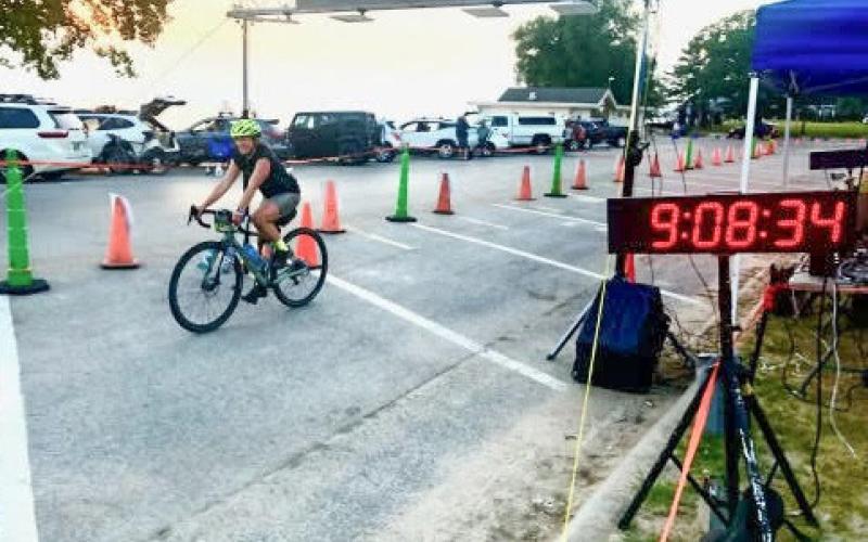 Pictured is a rider leaving the first checkpoint at Gladwin High School. Inset photo, Katie Keen crossing the finish line at 9:08 p.m. after 15 hours of riding.
