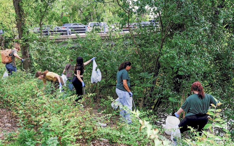 Volunteers clean up garbage along the Red Cedar River in East Lansing. MICHIGAN STATE UNIVERSITY