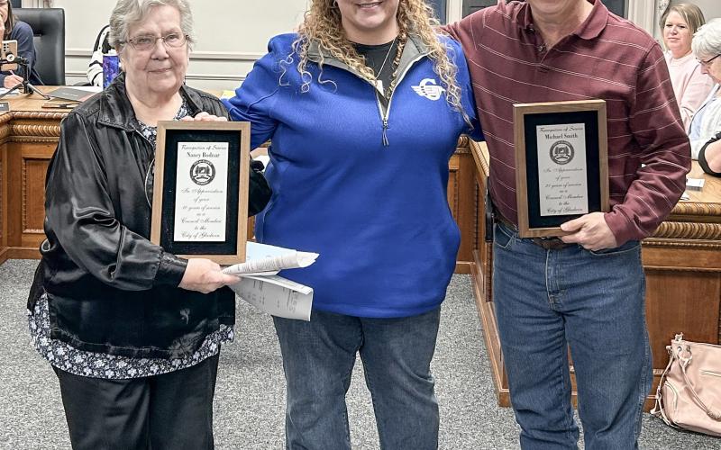 Nancy Bodnar (left) and Michael Smith (right) received awards for their years of service on the Gladwin city council. Mayor Sarah Kile presented the awards.