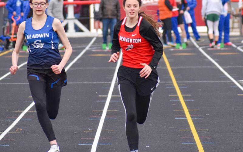 Lady Beavers, slightly ahead of the Flying G’s as the two girls run the track.