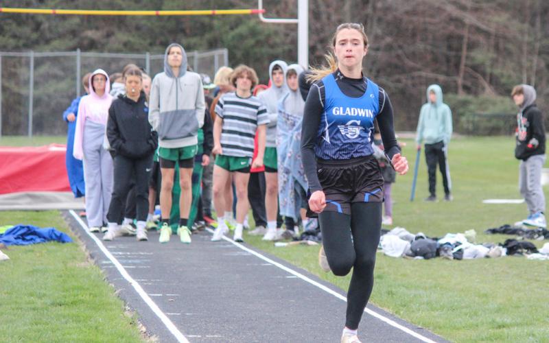Abby Robinson makes her way down the runway, competing in the long jump.