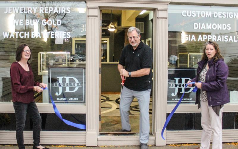 J.D. Jewelers owner David Jenkins (center) cutting the ribbon with Vicki Pickard (right) and Carrie Will, Gladwin Chamber of Commerce Executive Director (left), at the new store location at 111 Cedar Avenue.