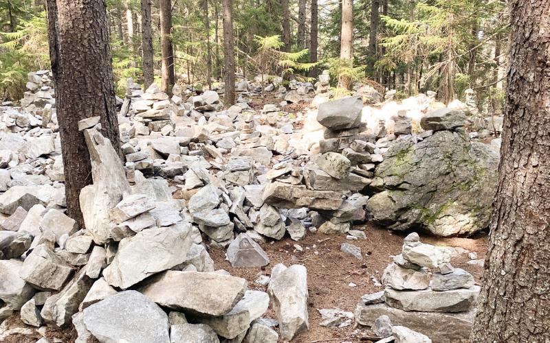Pictured above, cairns litter the trail near Stratton Mountain. Inset photo is the fire tower at the top of Stratton Mountain. Pictured at right, the AT goes through large granite boulders. Inset photo, 500 mile-marker to Mount Katahdin in Maine.