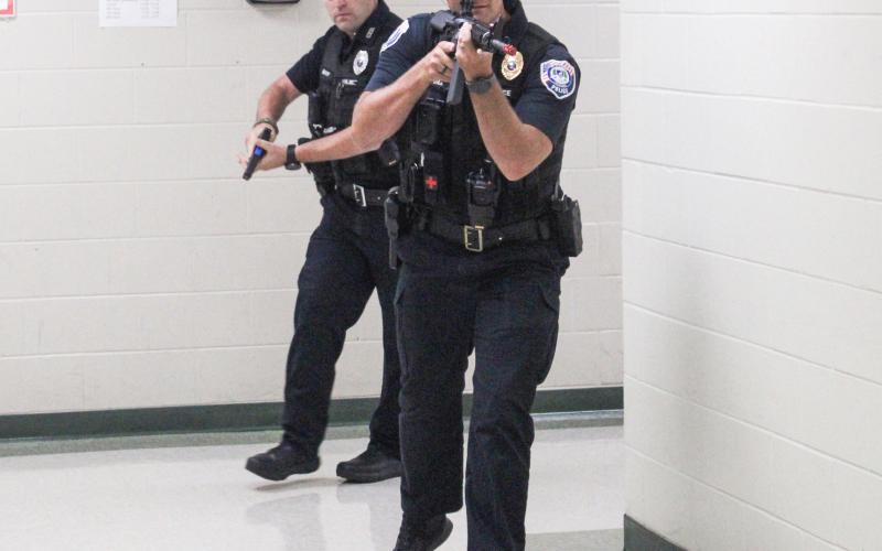 Police officers practice dealing with an active assailant situation during a training session at Gladwin Junior High School Thursday that involved multiple local agencies.
