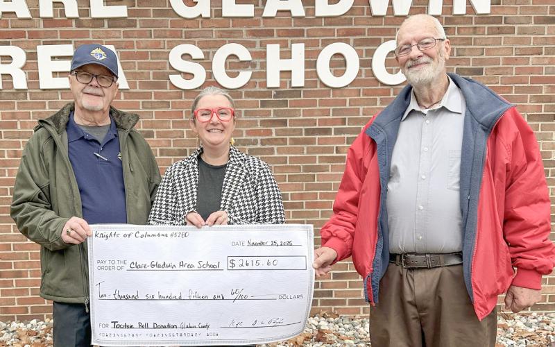 Gladwin Knights of Columbus Council 5280 representatives, Scott Cody and Dave Poxon, present a check to Principal, Beth Wood.