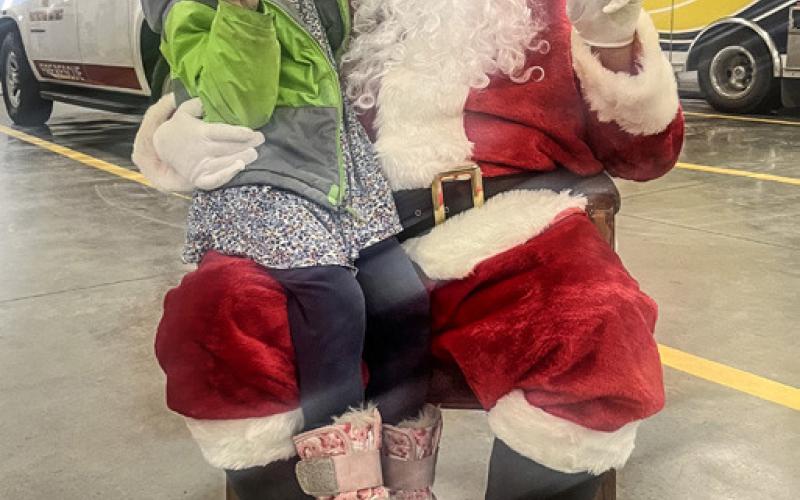 Officer Miller shopped with student Kaden on December 14. Inset photo, Santa visited the Beaverton Area Fire Department spending time with heroes and students.