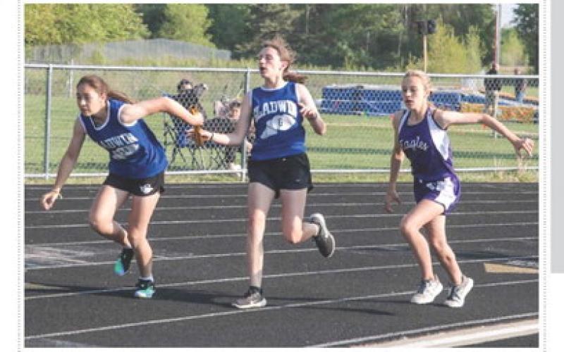 Ruby Vannest hands off to Elizabeth Huisjen during the Conference Championship’s relay race. PHOTO PROVIDED BY ANN MANNING
