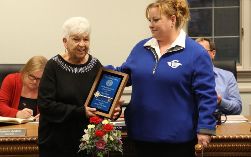 Former Gladwin Mayor, Dee Jungman (left) is presented with a key to the city by Mayor Kile during the Gladwin City Council meeting on Monday.