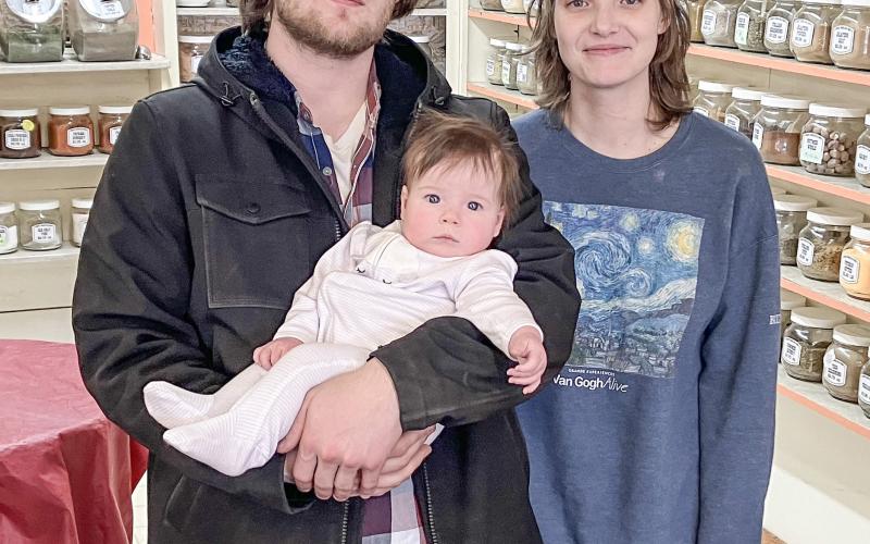 Gabriel Hadley is pictured with baby Meredith, and wife, Lilly.