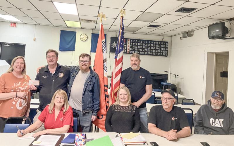 Gladwin County Office of Veterans Affairs Director Ken Roberts (back row, second from left) accepts a donation from the officers of the Gladwin Eagles 3292 Riders at a meeting of the club Friday night