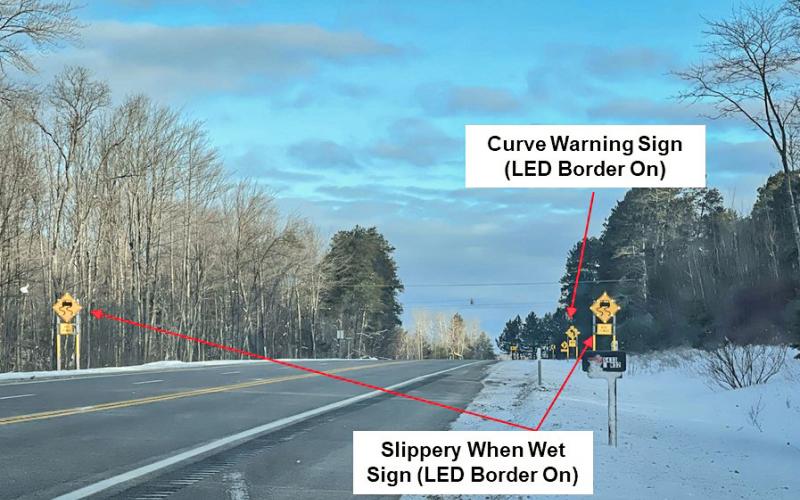 Example of activated slippery curve warning system signs on westbound M-32 near Gaylord. MICHIGAN STATE UNIVERSITY