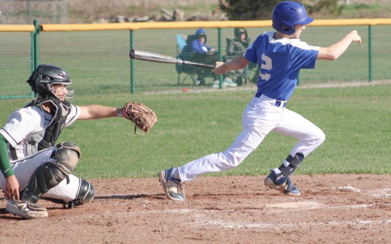 Gladwin’s Brady Demory watches the flight of the ball after getting a hit in a game earlier this season.