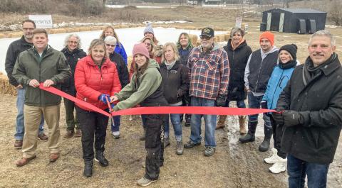 Gladwin Interim City Administrator Kimberly Hines and City Park Manager Sabrina Battjes handle the big scissors Saturday at a ribbon cutting to open the new North Park Winter Wonderland.