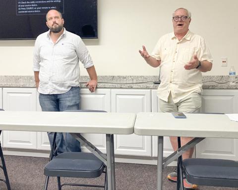 Environmental advocates Sean McBrearty (left) and David Holtz address a crowd of citizens Monday evening at the Gladwin County District Library, detailing their opposition to the proposed construction of an oil tunnel beneath the Straits of Mackinac.