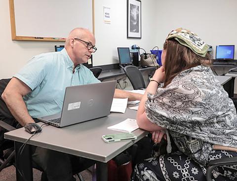 Jeff Thompson with the MDOS triage team provides expert guidance on driver’s license restoration to an attendee at the Gladwin clinic.