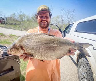 Sedrick Neinhuis holding the state-record gizzard shad he caught April 22 in the Grand River (Kent County). The new state record gizzard shad weighed 4.45 pounds and measured 20.3 inches long.