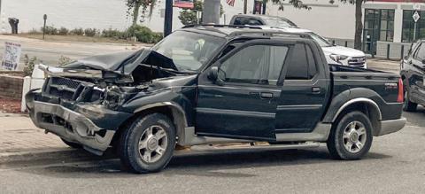 Pick-ups collide in center of town