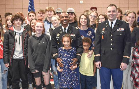 Beaverton High School teacher Kossi Komlassan poses with his family, his commanding officer and his students after the school hosted a ceremony when he was promoted to the rank of major in the Army National Guard.