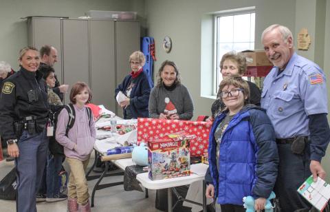 After a big Christmas shopping trip, the next step is to wrap the presents and that’s what this bunch was up to Thursday at the Beaverton Fire Dept. during the annual Shop With A Hero festivities.